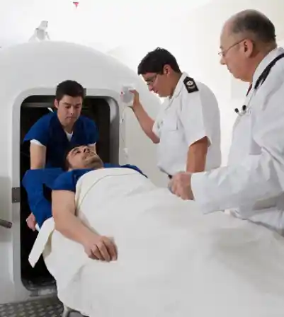 A patient receiving hyperbaric oxygen therapy in a pressurized chamber