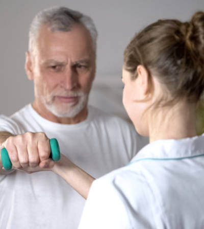 Patient exercising under supervision at a cardiac rehabilitation center