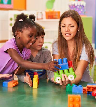 Children playing under staff supervision at a day care center