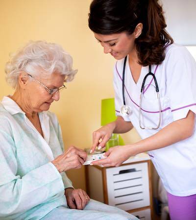 A nurse caring for a resident in a skilled nursing facility